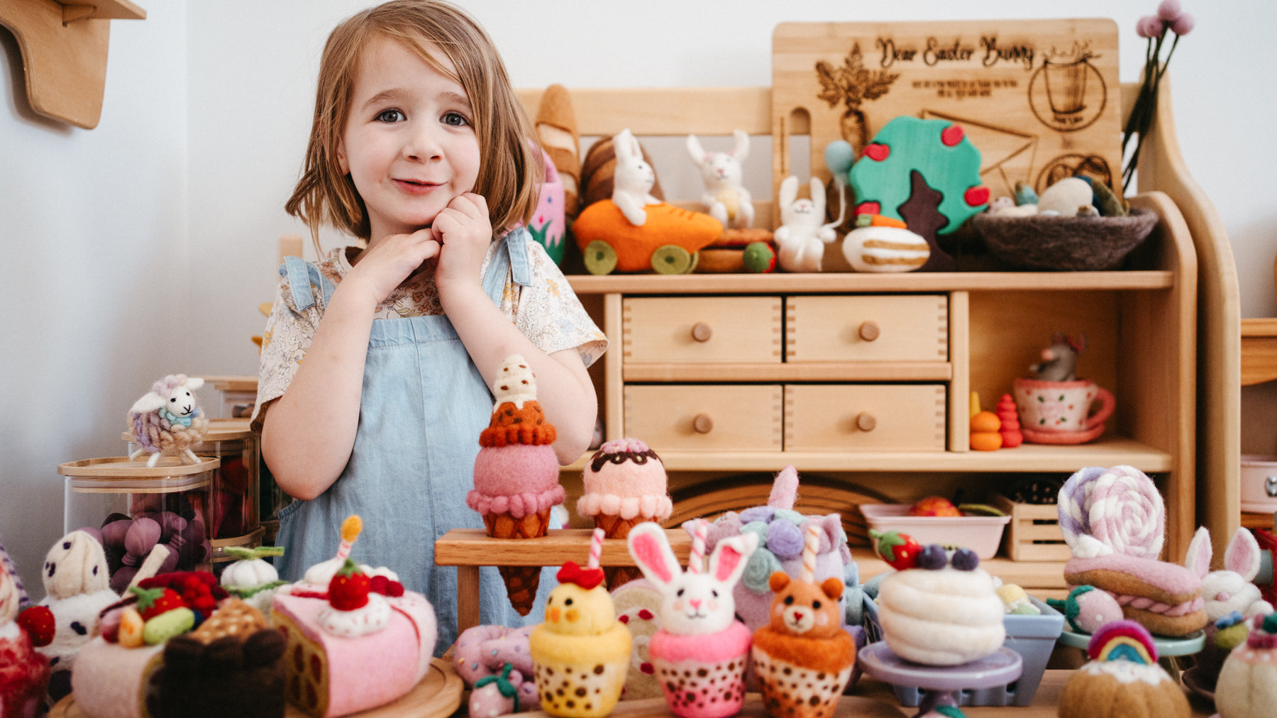 Preschooler setting up a felt fruit market